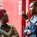 Two people facing eachother in discussion.