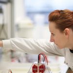 Researcher in the lab wearing white lab coat.