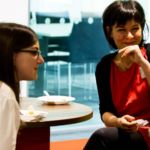 People sat around a table networking and chatting.